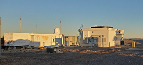 >SGSLR shelter (building to the right) before the dome installation.  The black dome ring wall can clearly be seen atop the SGSLR shelter.  The legacy MLRS SLR system with its radar on top is to the left in the picture..